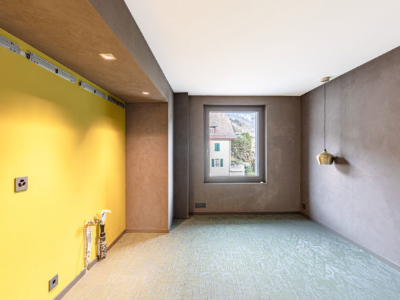 Chambre avec mur jaune et moquette texturée