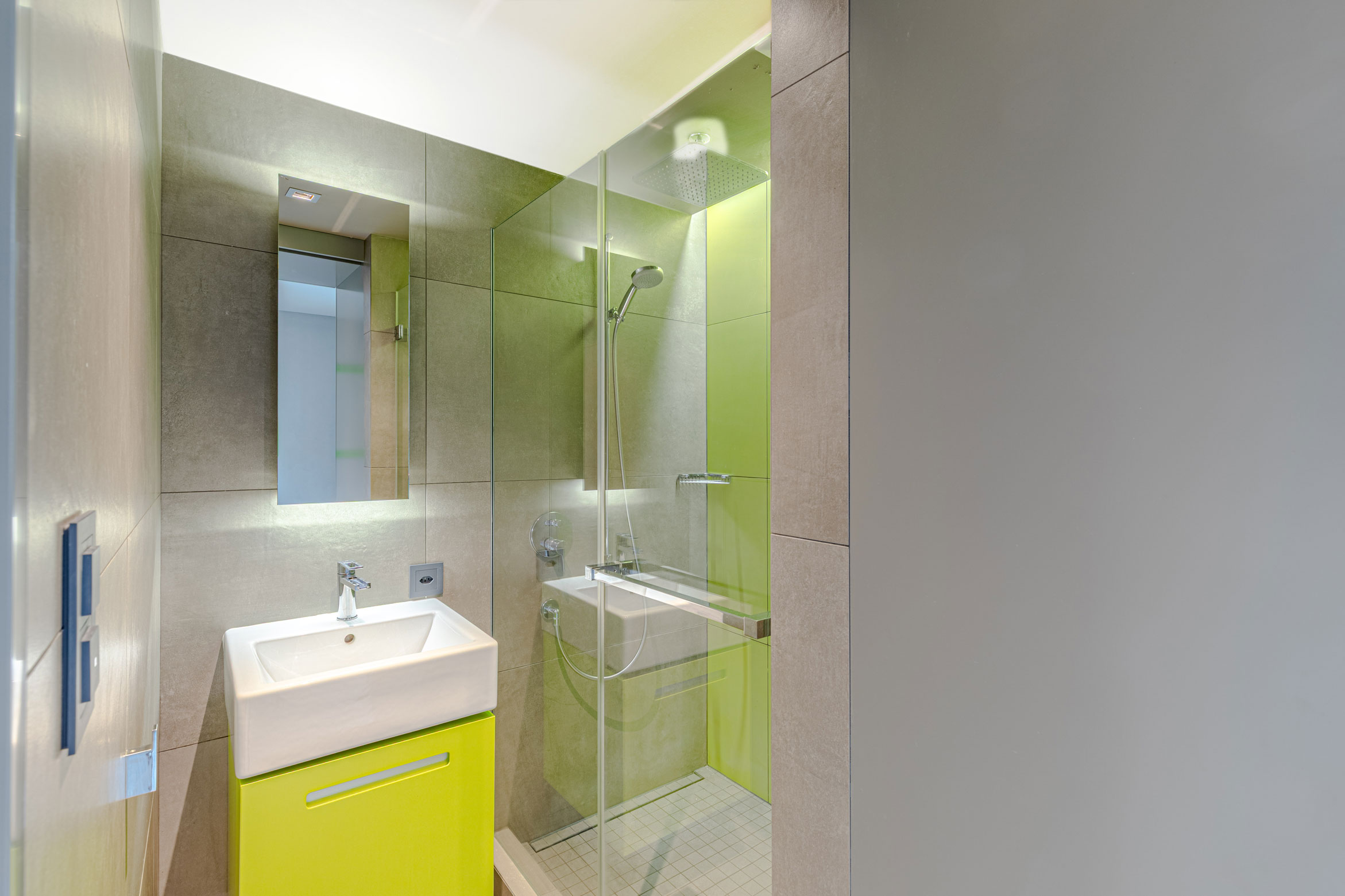 Salle d’eau avec meuble vasque vert et douche vitrée